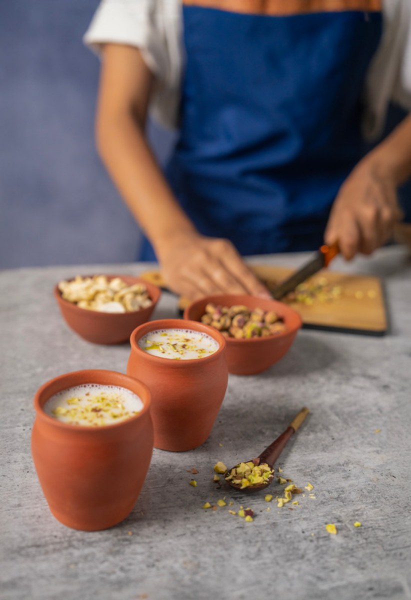 Quinoa kheer served in clay cups with chopped nuts on top
